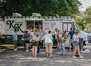 A picture of the ice cream truck with customers